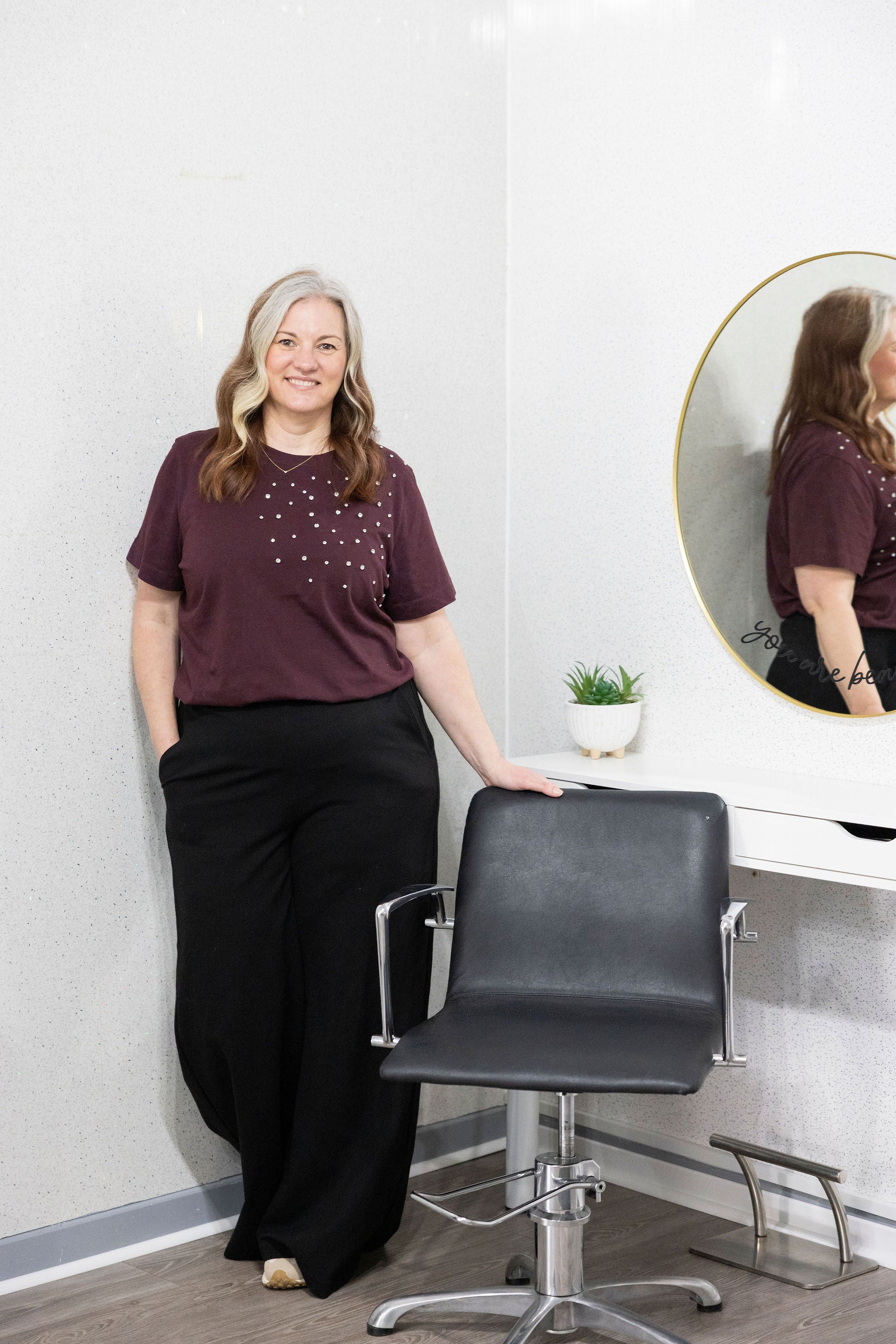 Claire welcoming a client at her stylish, coastal hair salon