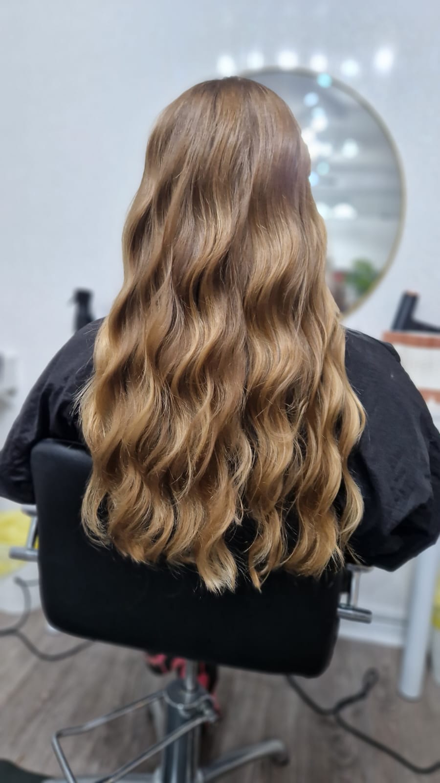 Soft caramel highlights on brunette hair at C.E Hair Salon